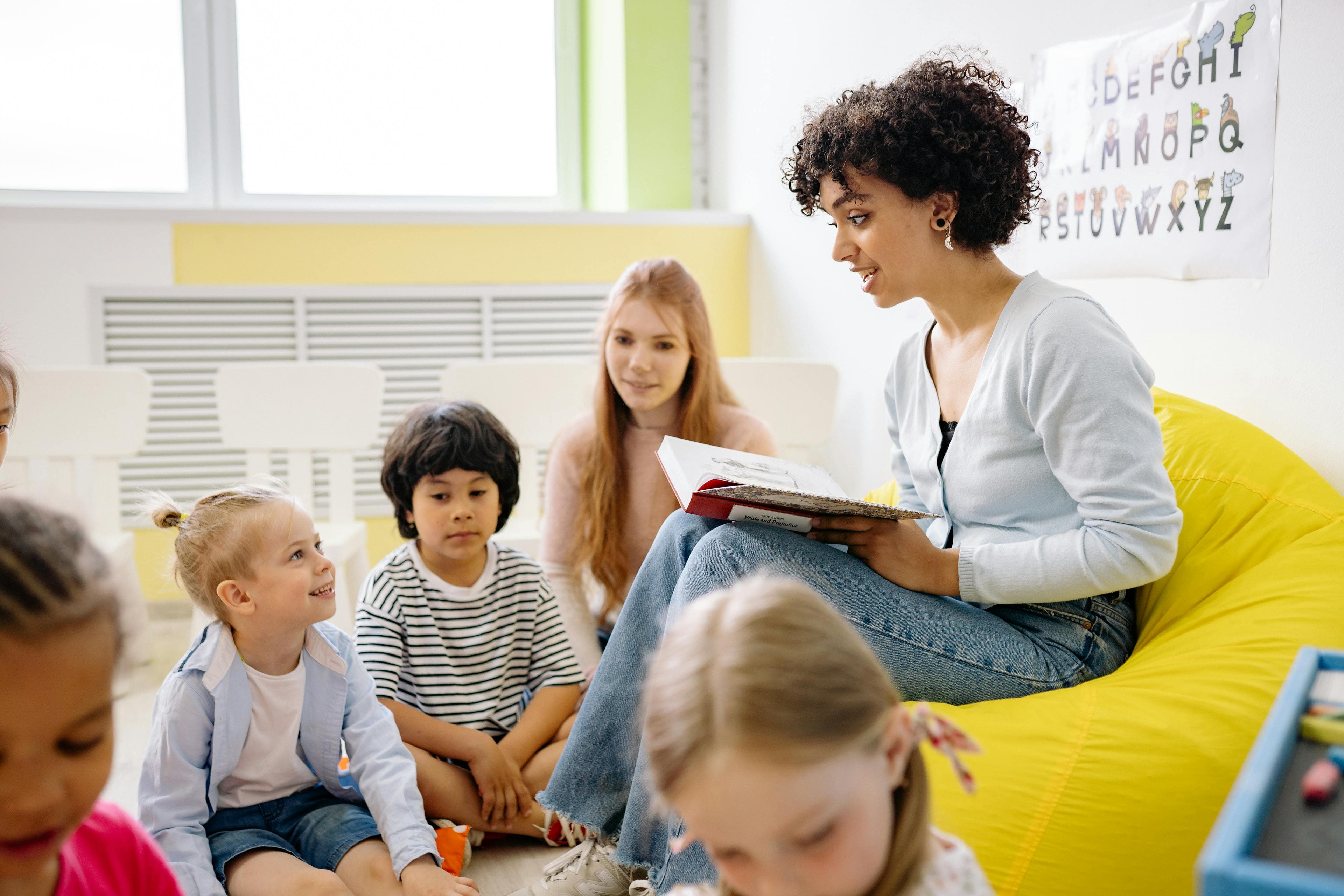 Teacher reading to young children in a preschool classroom